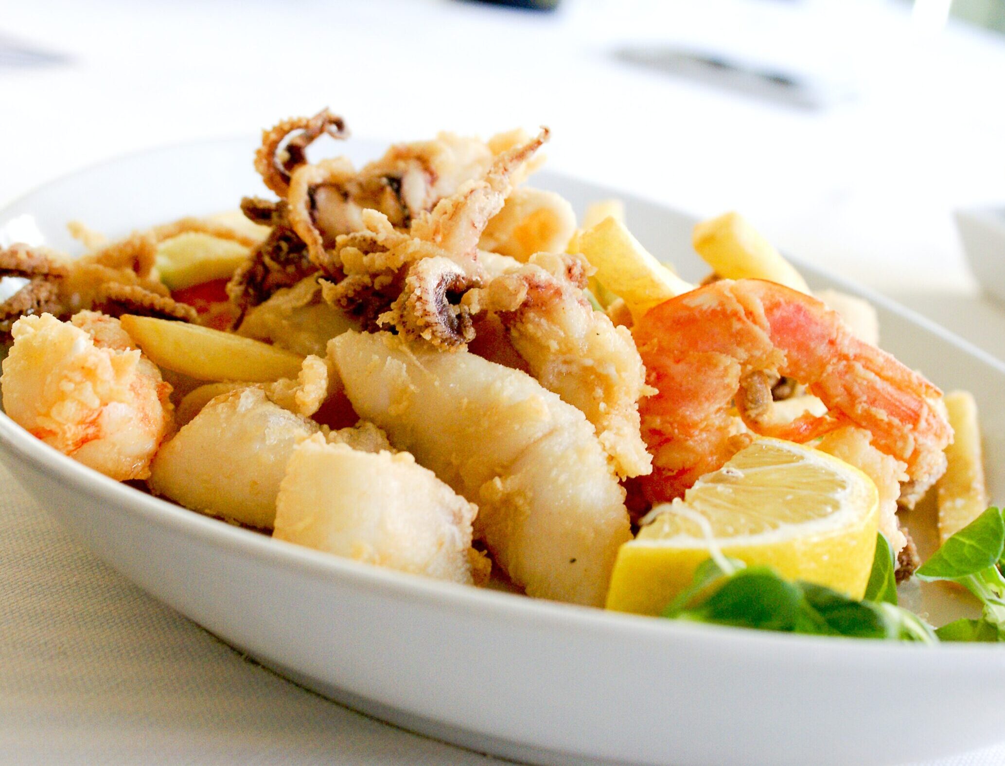 Actual item may vary from image shown Deep Fried Shrimp and Squid With Slice of Lemon on Ceramic Plate